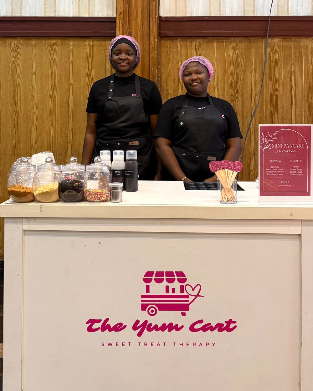 The Yum Cart team behind the branded cart at an event